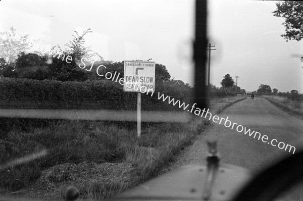 THROUGH WIND SCREEN 'DEAD SLOW  DEATH TRAP' SIGN